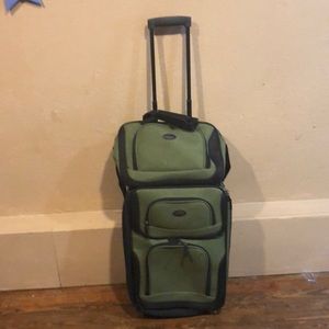 Green suitcase with travel bag
